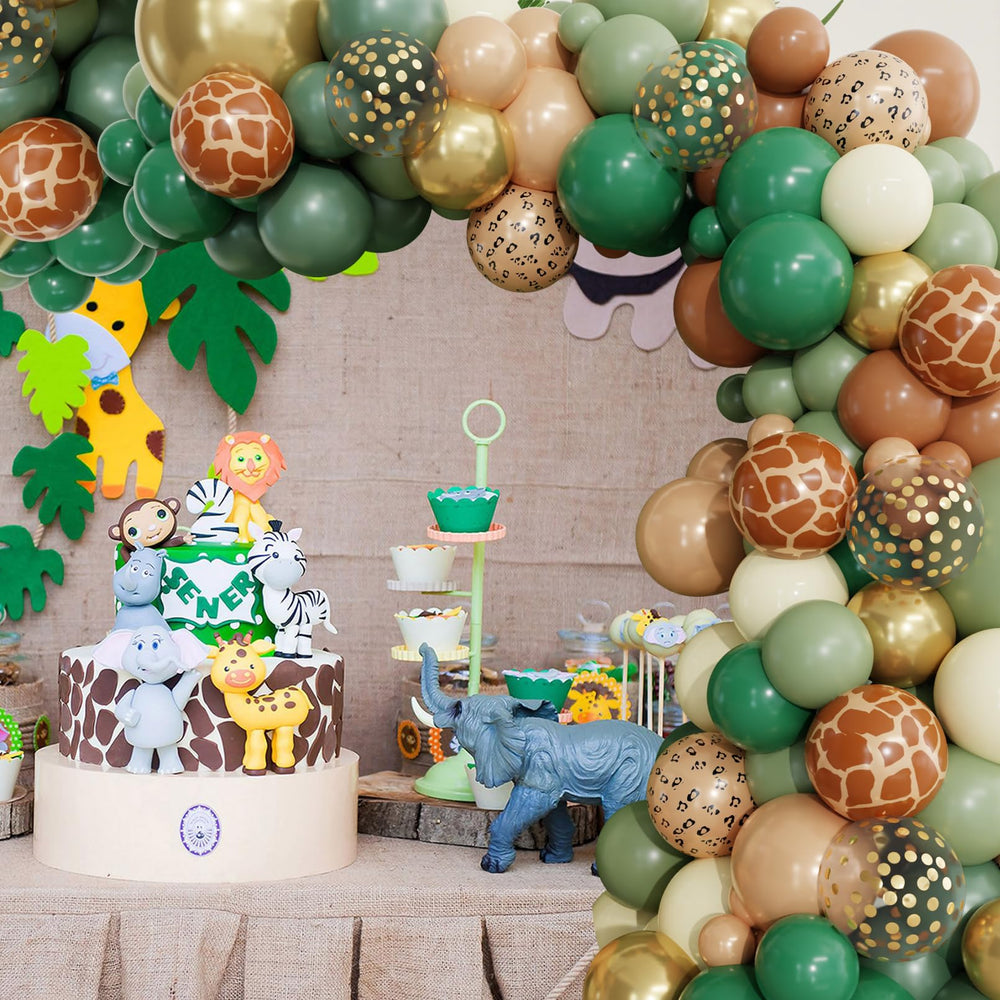 Ouddy Party woodland baby shower setup with greens and prints