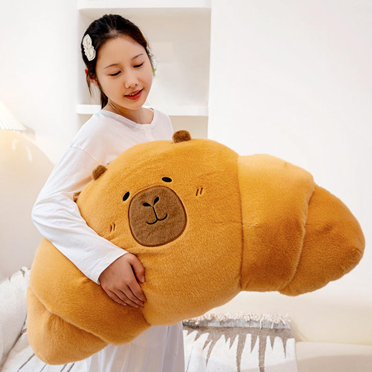 PEACH CAT croissant capybara plush, front view, a cozy backrest for reading and lounging.