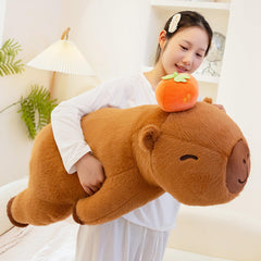 Peach Cat Persimmon Capybara plush head detail with lucky fruit motif.