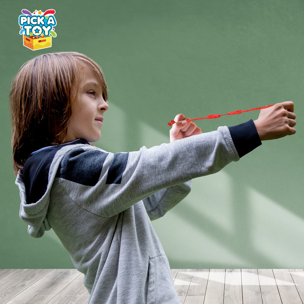 PICK A TOY surface adhesion demo emphasizes kid-safe rubber grip on glass and walls.