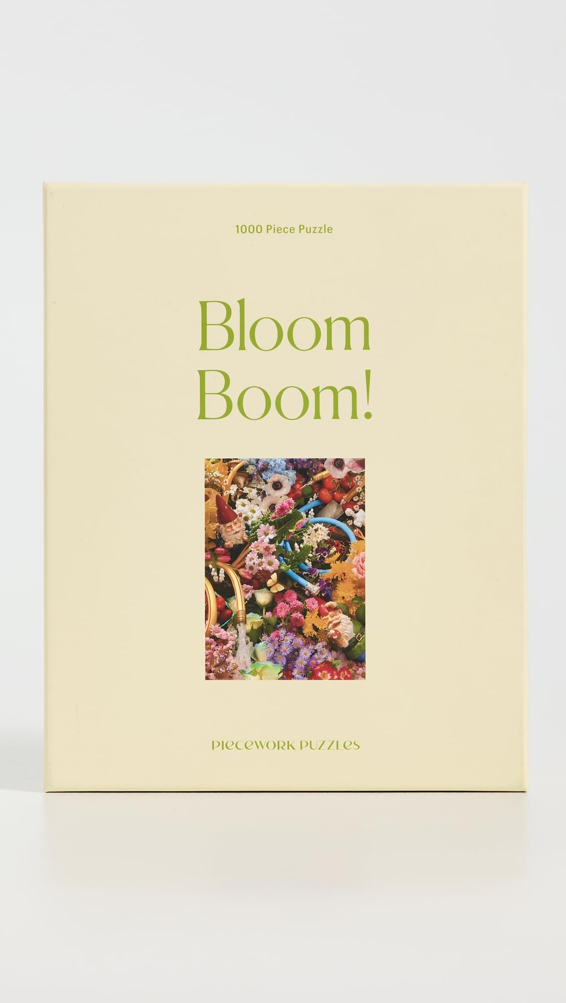 Piecework Bloom Boom assembled puzzle on table showcases a rainbow of petals, perfect for framing