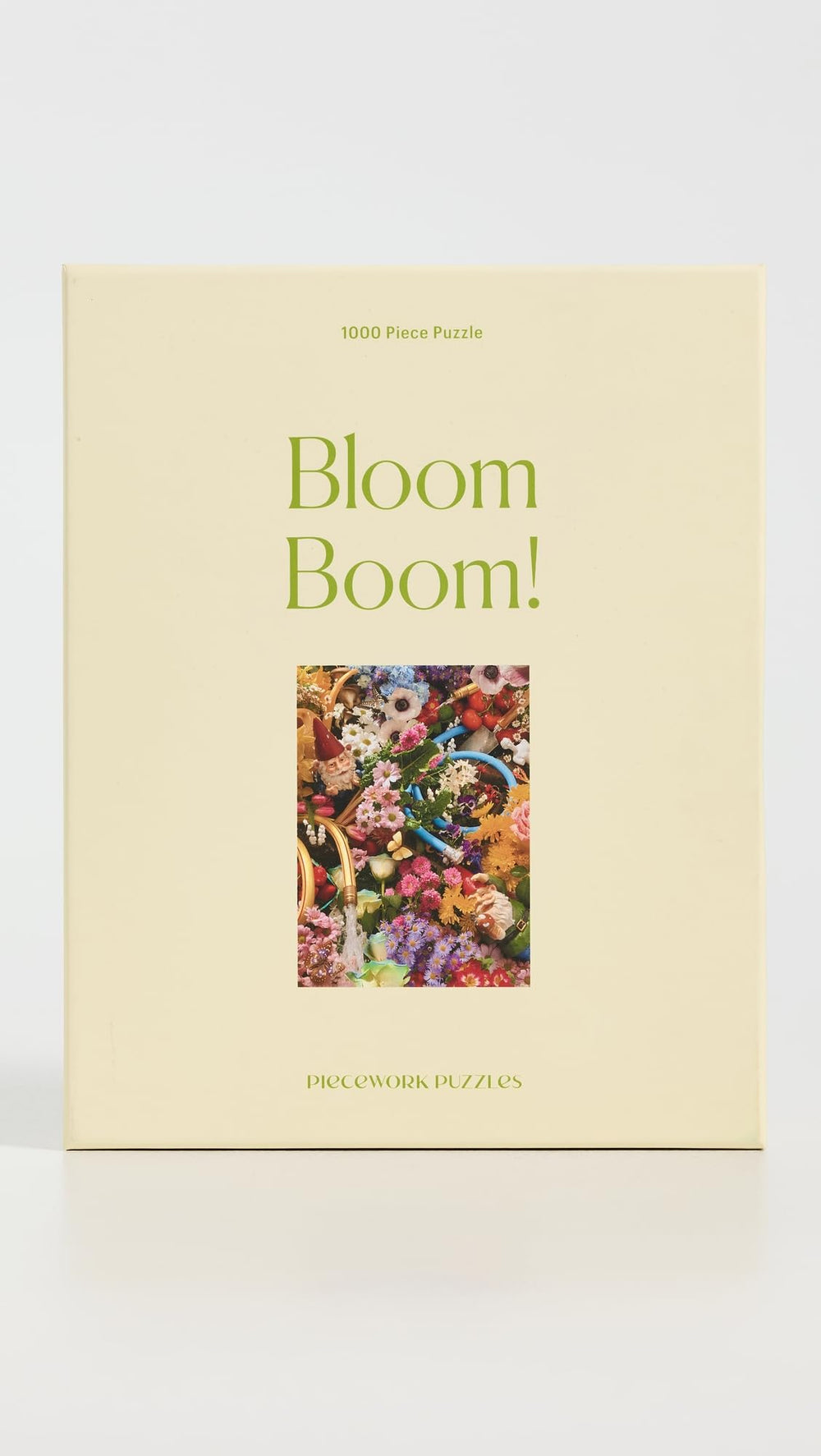 Piecework Bloom Boom assembled puzzle on table showcases a rainbow of petals, perfect for framing