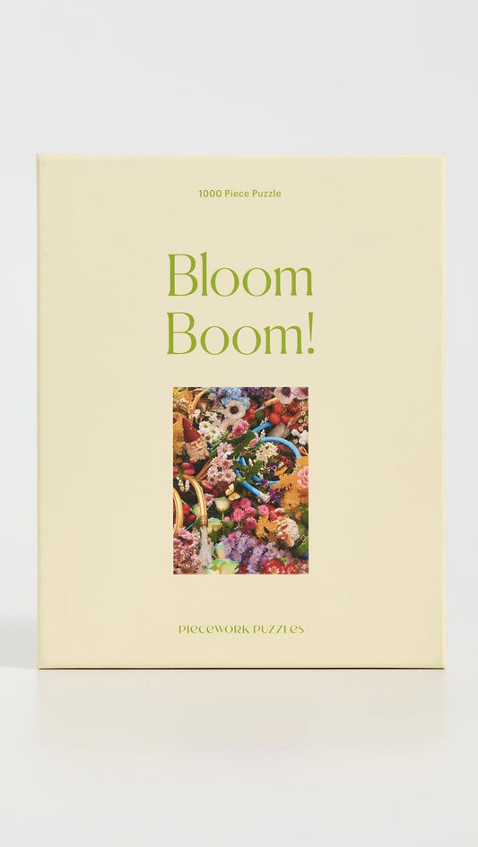 Piecework Bloom Boom assembled puzzle on table showcases a rainbow of petals, perfect for framing