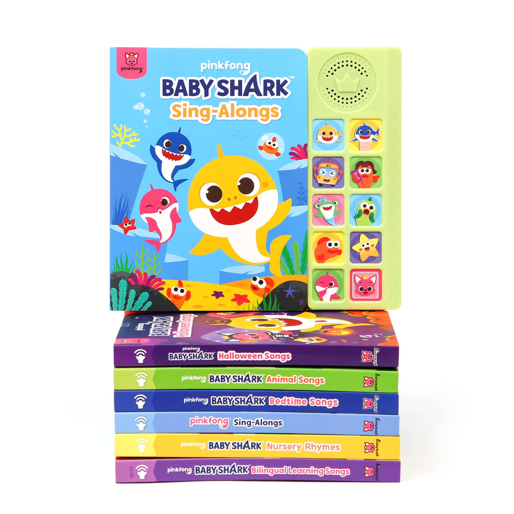 Child enjoying reading and singing with Pinkfong Baby Shark sound book during playtime.