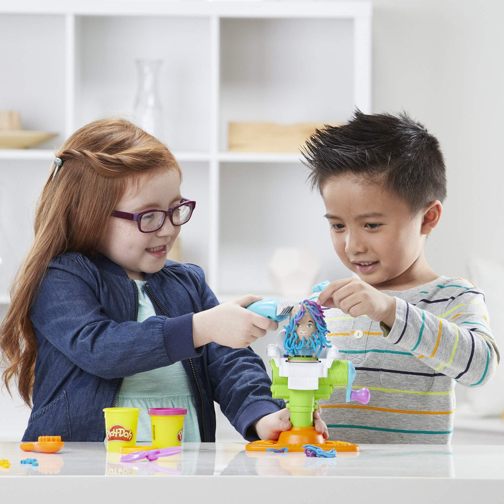 Play-Doh Buzz 'n Cut brush helps clean up leftover dough pieces.