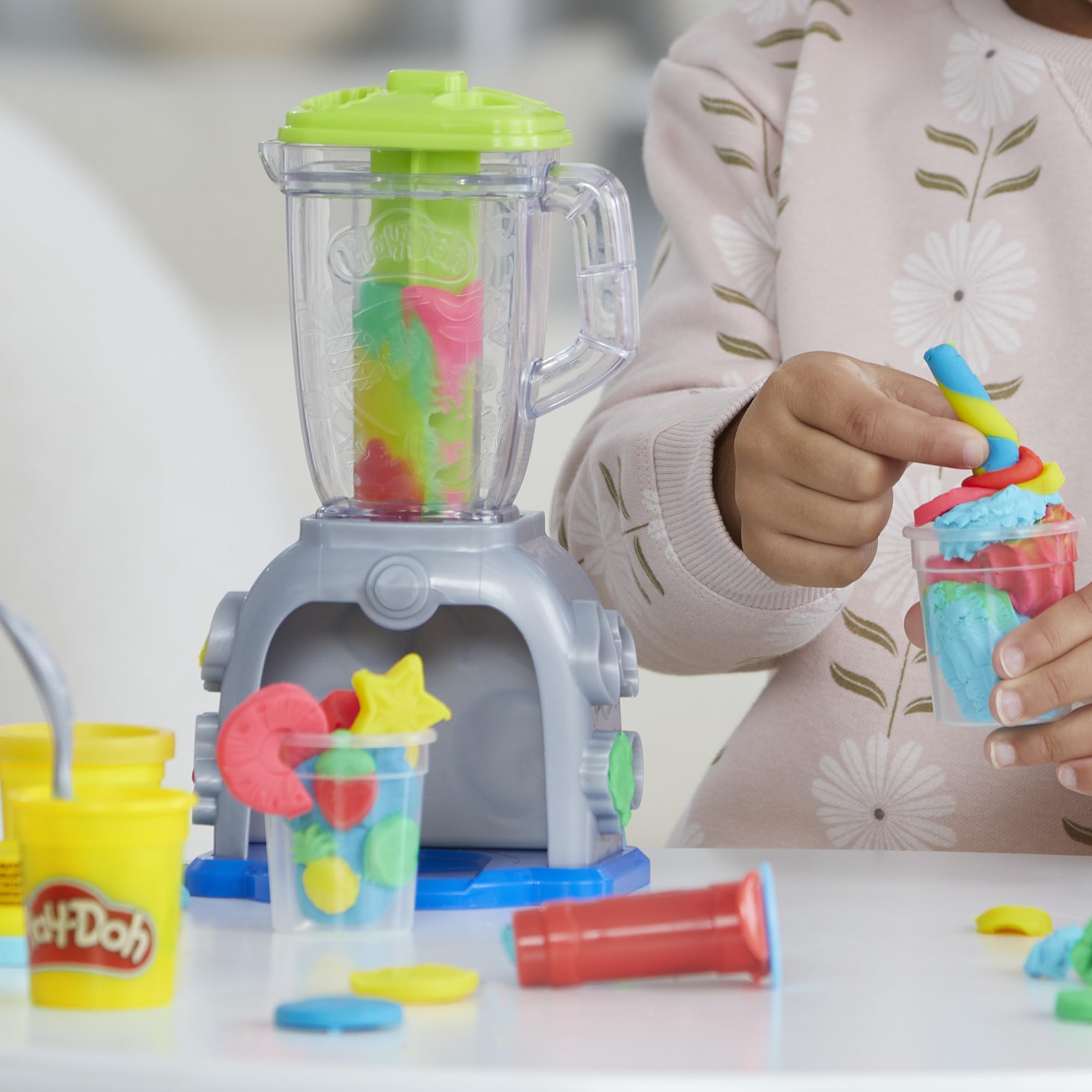 Five Play‑Doh cans arranged to show included colors and portion sizes for mixing