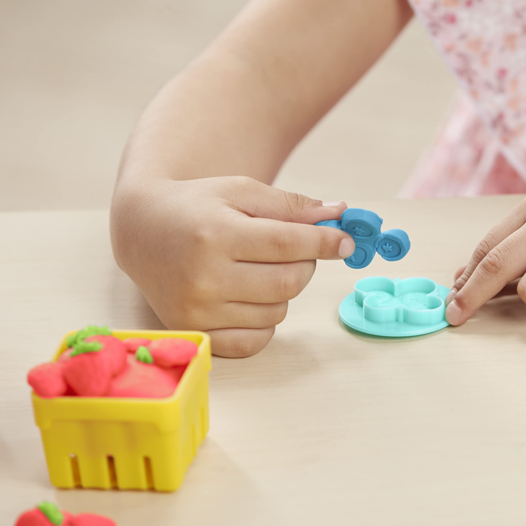 Play-Doh juice squeezer demonstrates fun fruit prep for décor and play.