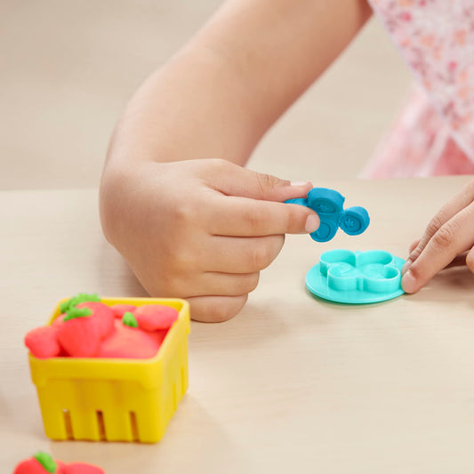 Play-Doh juice squeezer demonstrates fun fruit prep for décor and play.