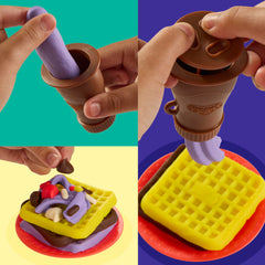Child pushing Play‑Doh into the waffle maker demonstrating simple hands‑on operation