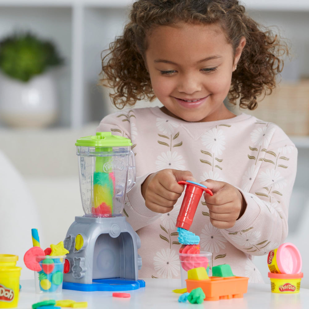 Preschool child playing with Play‑Doh blender promoting social and role play