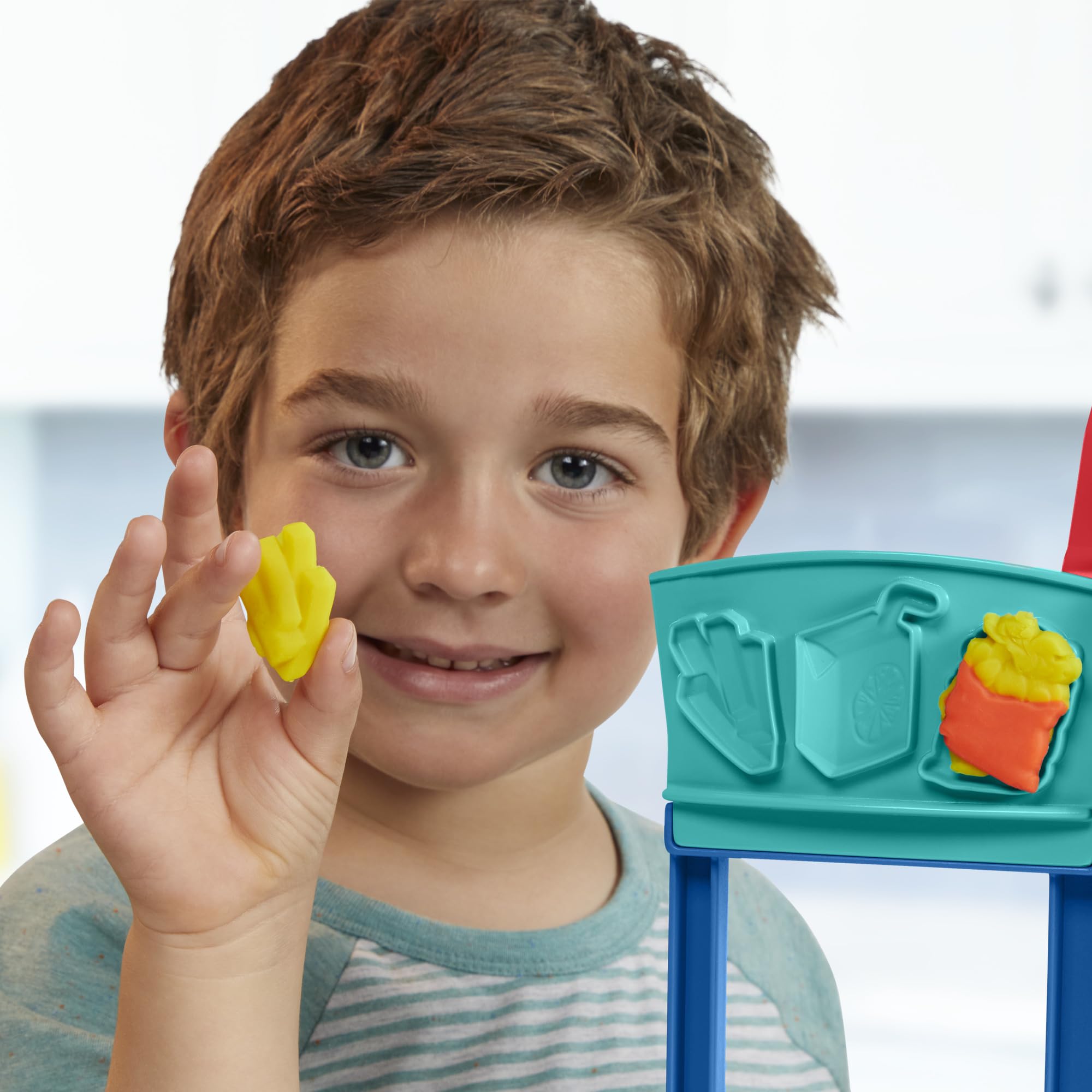 Play-Doh Kitchen Creations Busy Chef's Restaurant Playset menu board supports daily specials during play.
