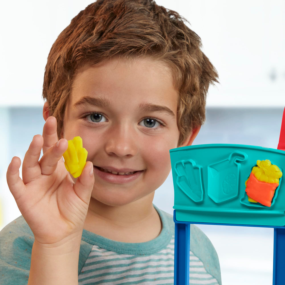 Play-Doh Kitchen Creations Busy Chef's Restaurant Playset menu board supports daily specials during play.
