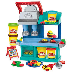Play-Doh Kitchen Creations Busy Chef's Restaurant Playset two-sided station invites role-play dining scenarios.