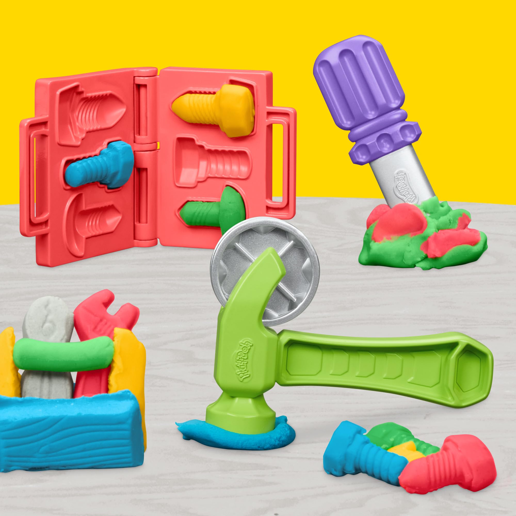 Play-Doh Stamp & Saw Tool Bench includes toy tools for pretend carpentry