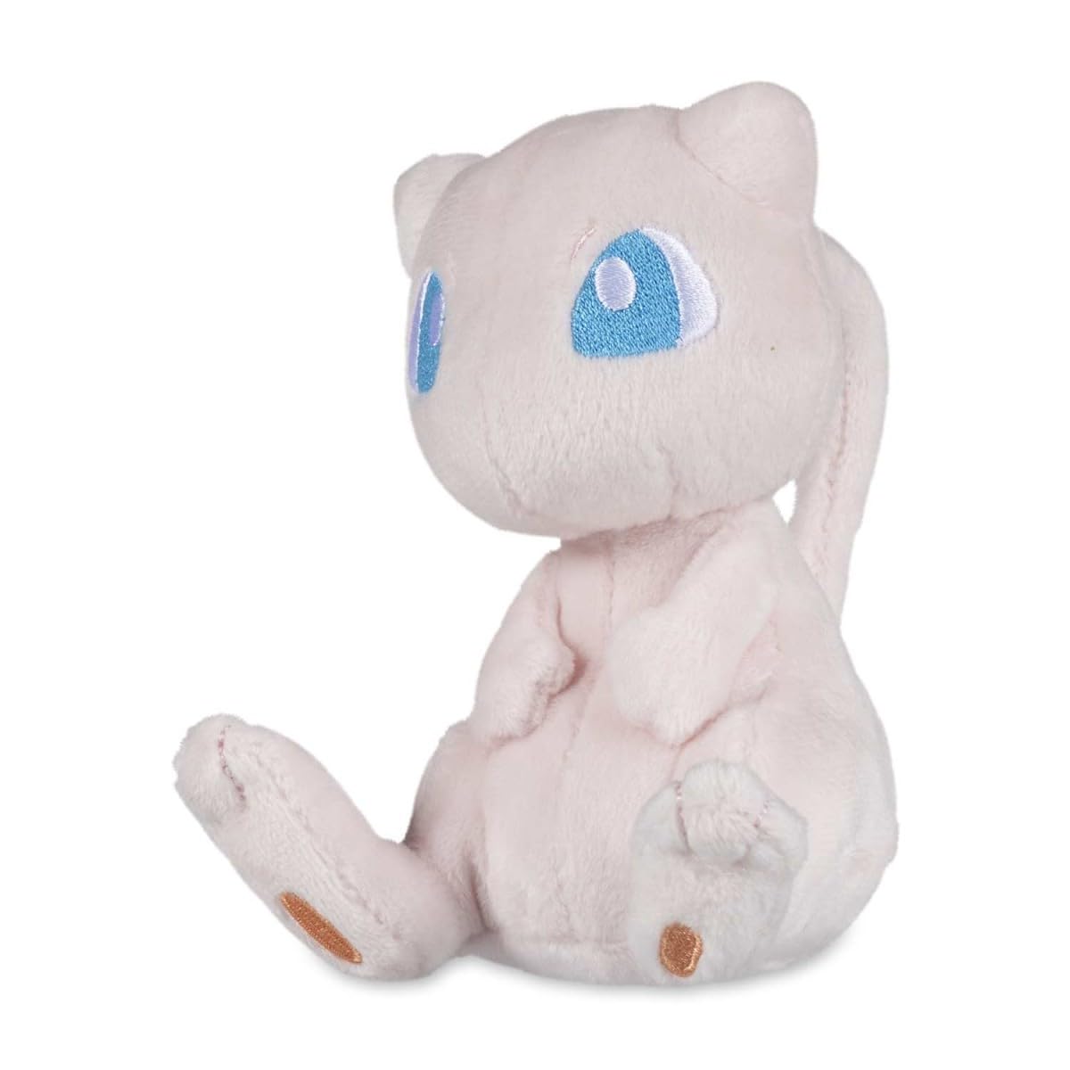 Pokémon Center Mew Sitting Cuties Plush sits upright on a desk for display.