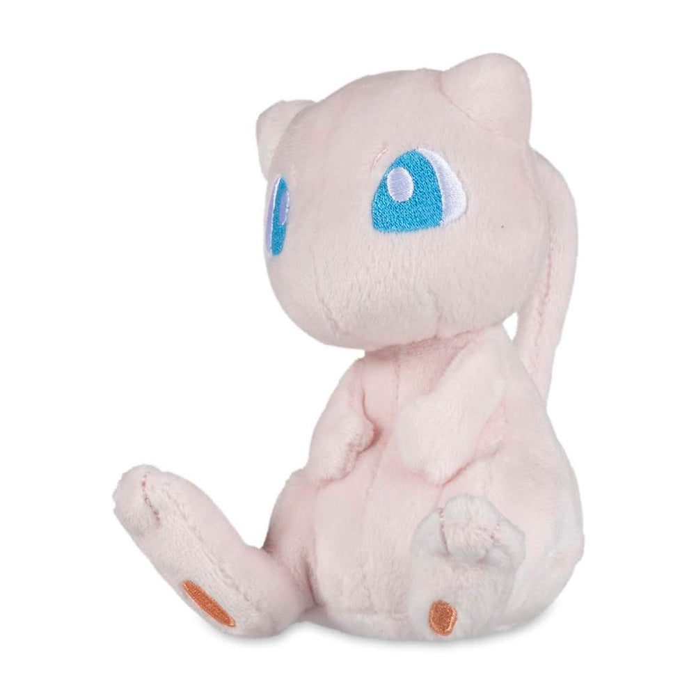 Pokémon Center Mew Sitting Cuties Plush sits upright on a desk for display.