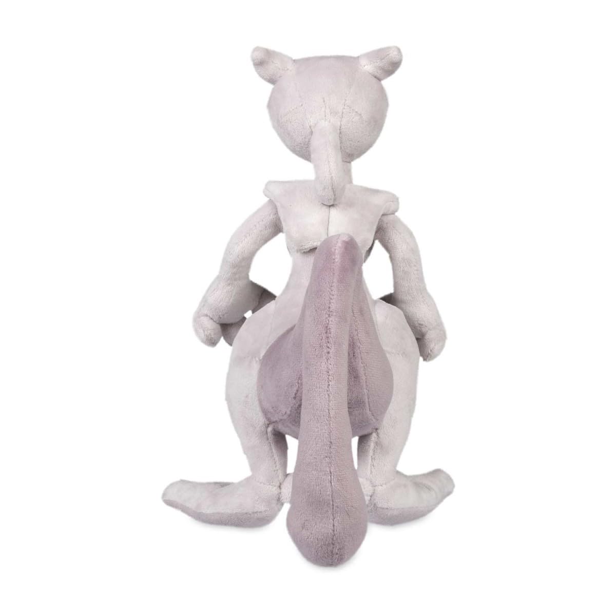 Pokemon Center Mewtwo plush on coffee table, adds collectible charm to living spaces.