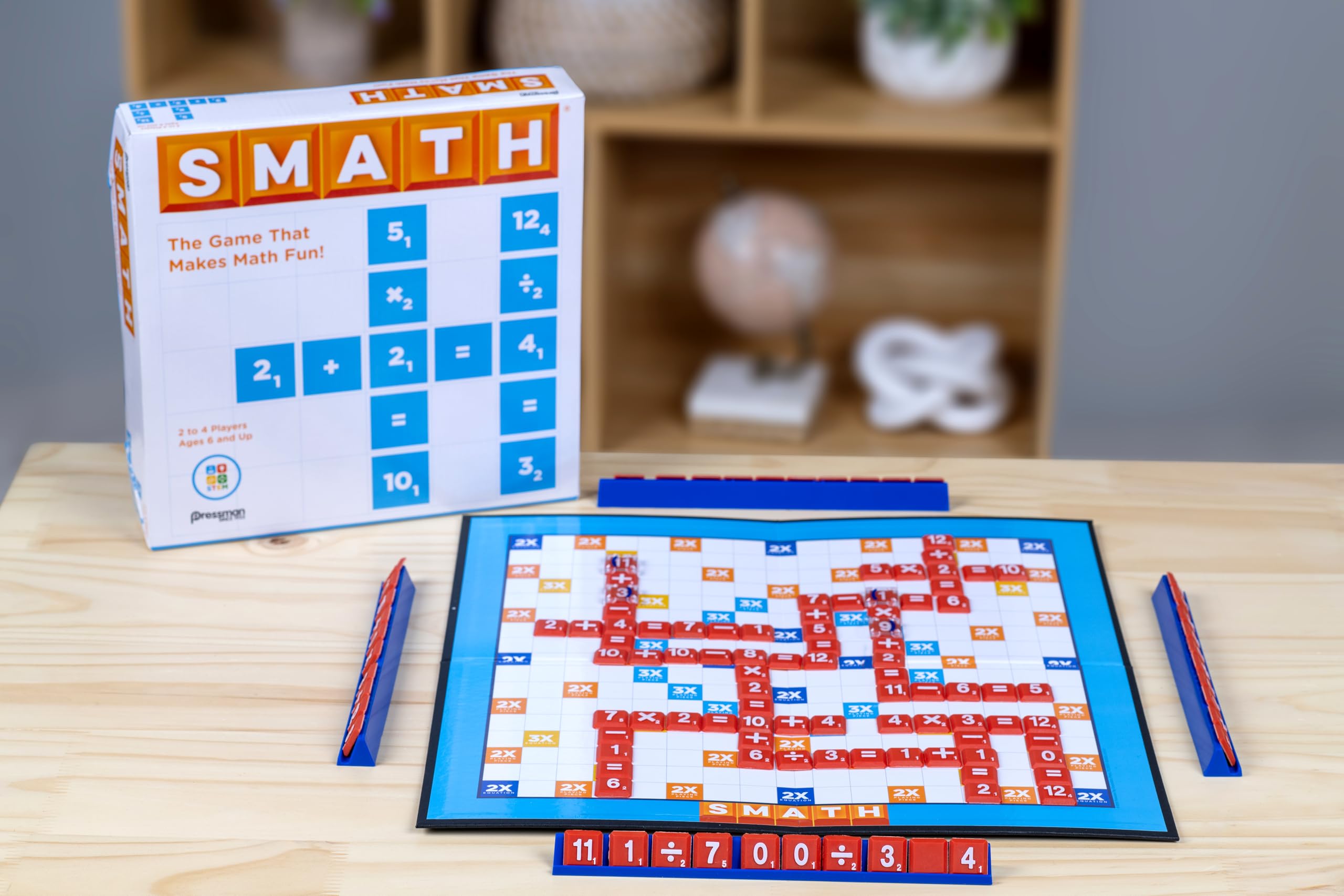Players around a Pressman SMATH board crafting crossword-style equations.