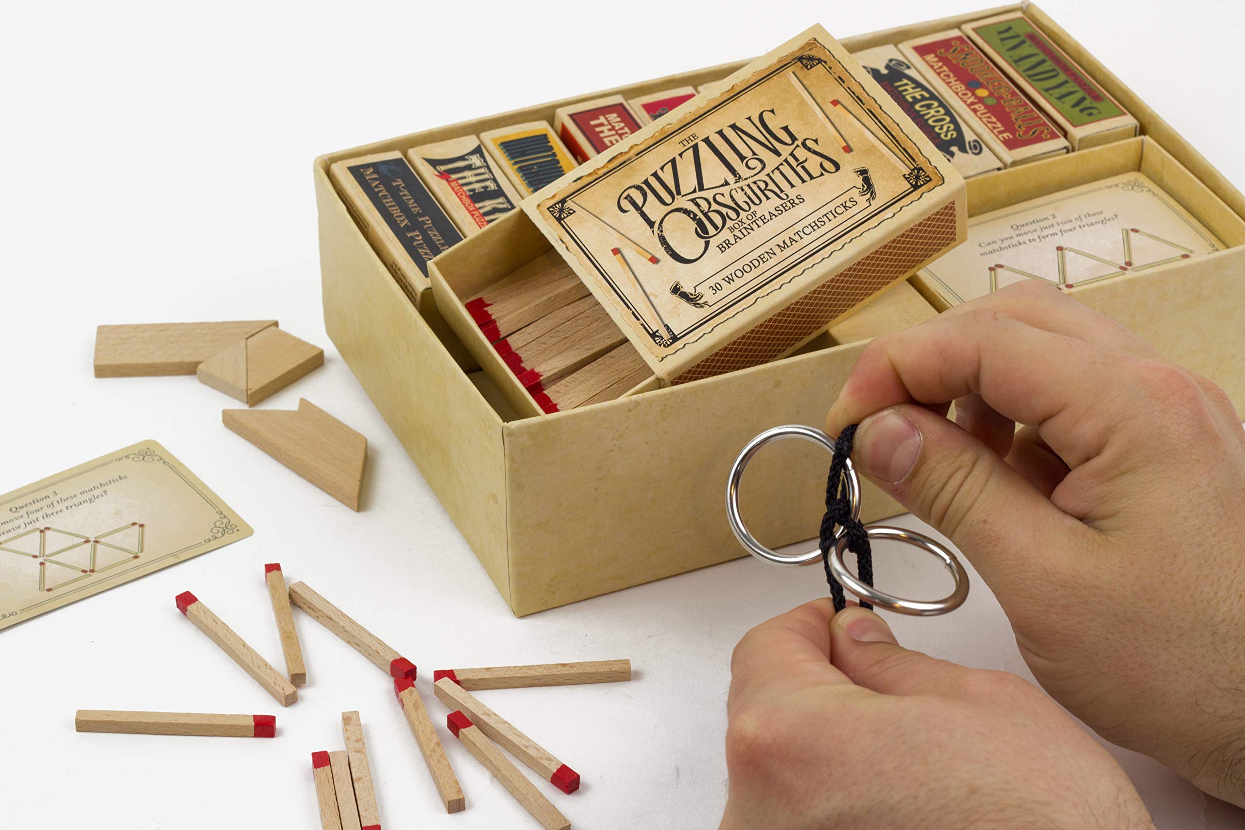 Matchbox puzzles lineup demonstrates ten tiny enigmas to solve.
