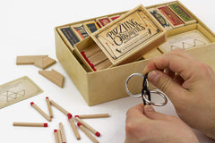 Matchbox puzzles lineup demonstrates ten tiny enigmas to solve.