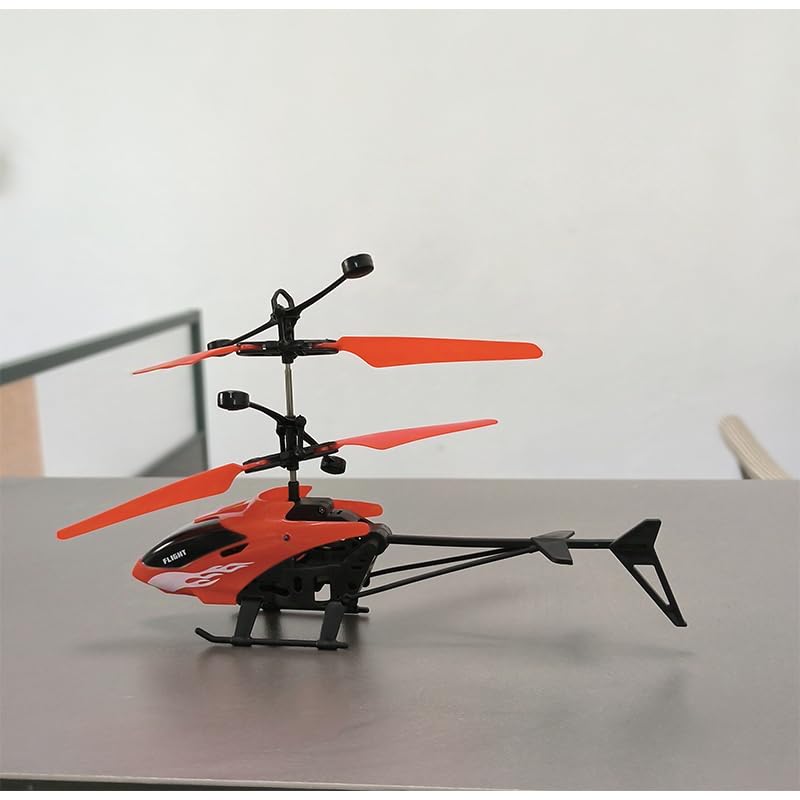 PTGHT gesture-sensing helicopter red, landing on table illustrating auto takeoff and landing