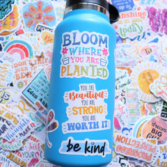 Puraesla stickers applied to notebooks and water bottles for versatile use