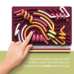 Pushpeel Sensory Activity Board handheld use demonstrates portable stress relief