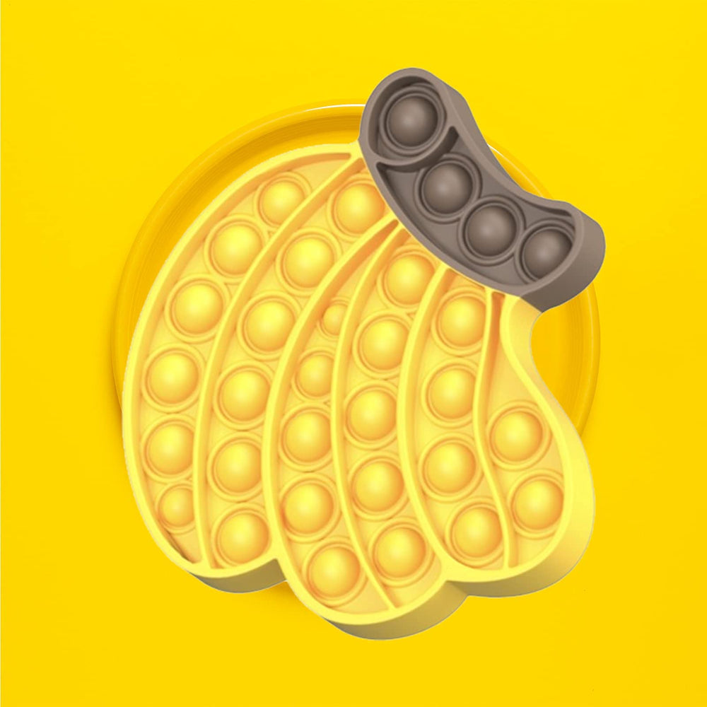 QETRABONE silicone fidget on desk used as a sensory coaster or playful tool.