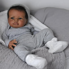 Realistic Black Boy 20-inch doll eyes convey expressive, lifelike gaze for nurturing play.