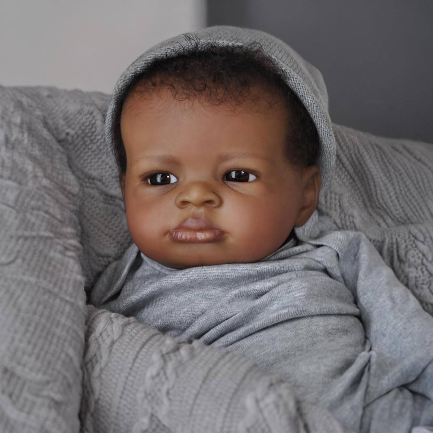 Realistic Black Boy 20-inch soft-cloth body with vinyl limbs feels substantial when held.