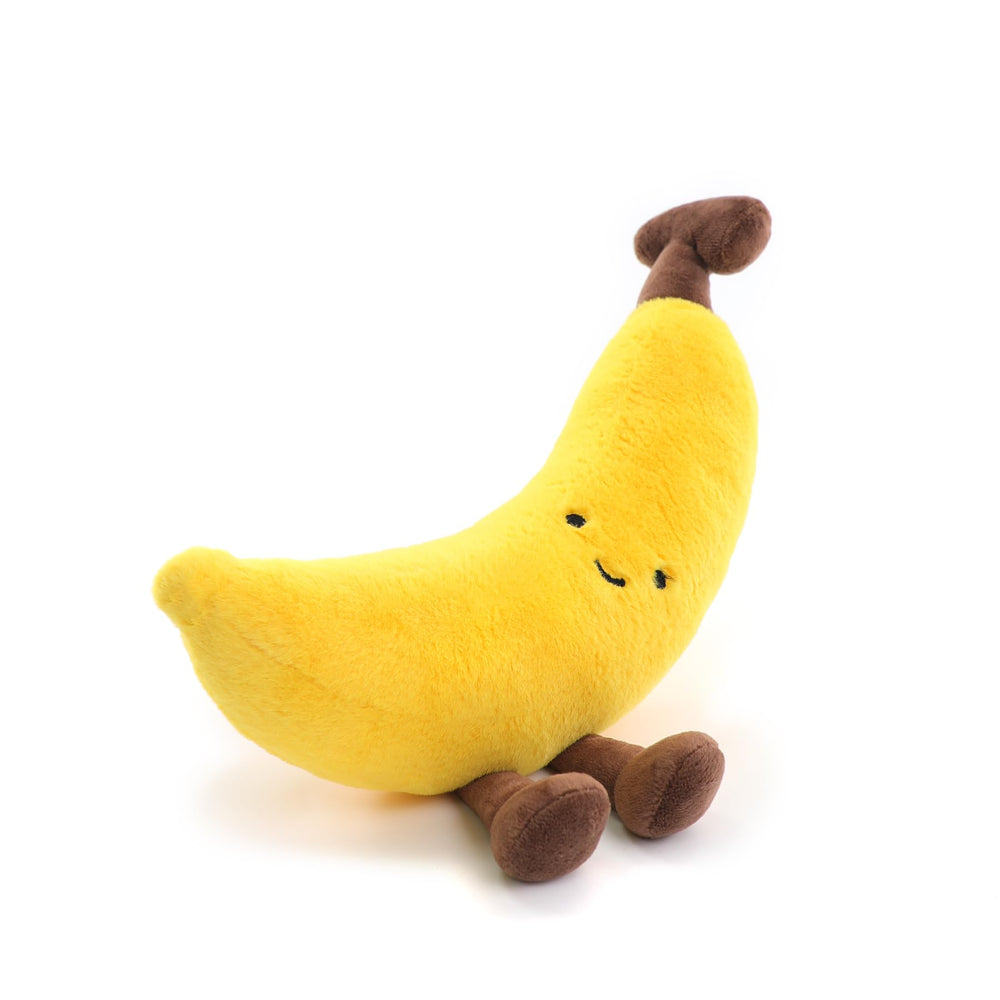 RECUR banana plush shown in cozy scenes for comfort during reading or travel.