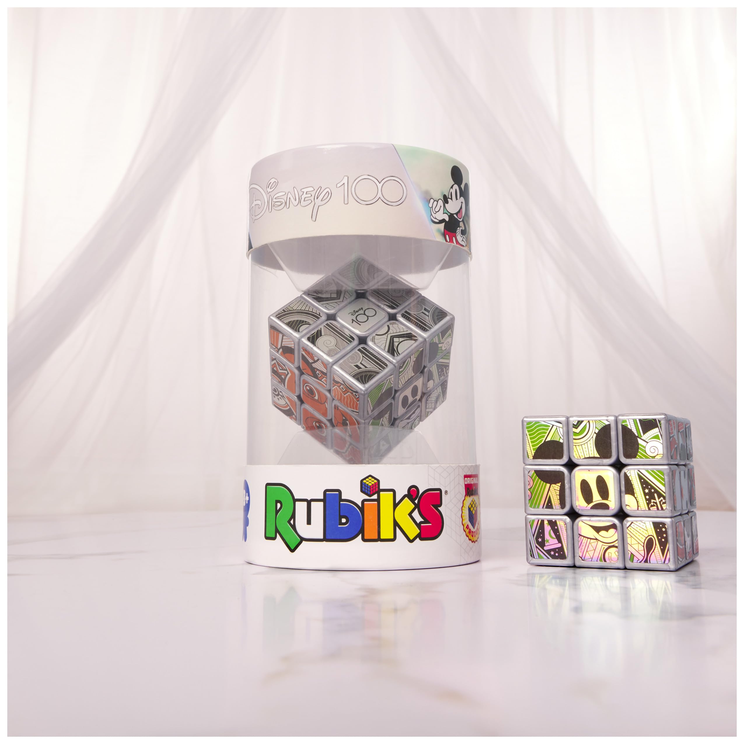 Rubik’s Disney100 Platinum Cube on desk, desktop challenge to boost focus and patience.