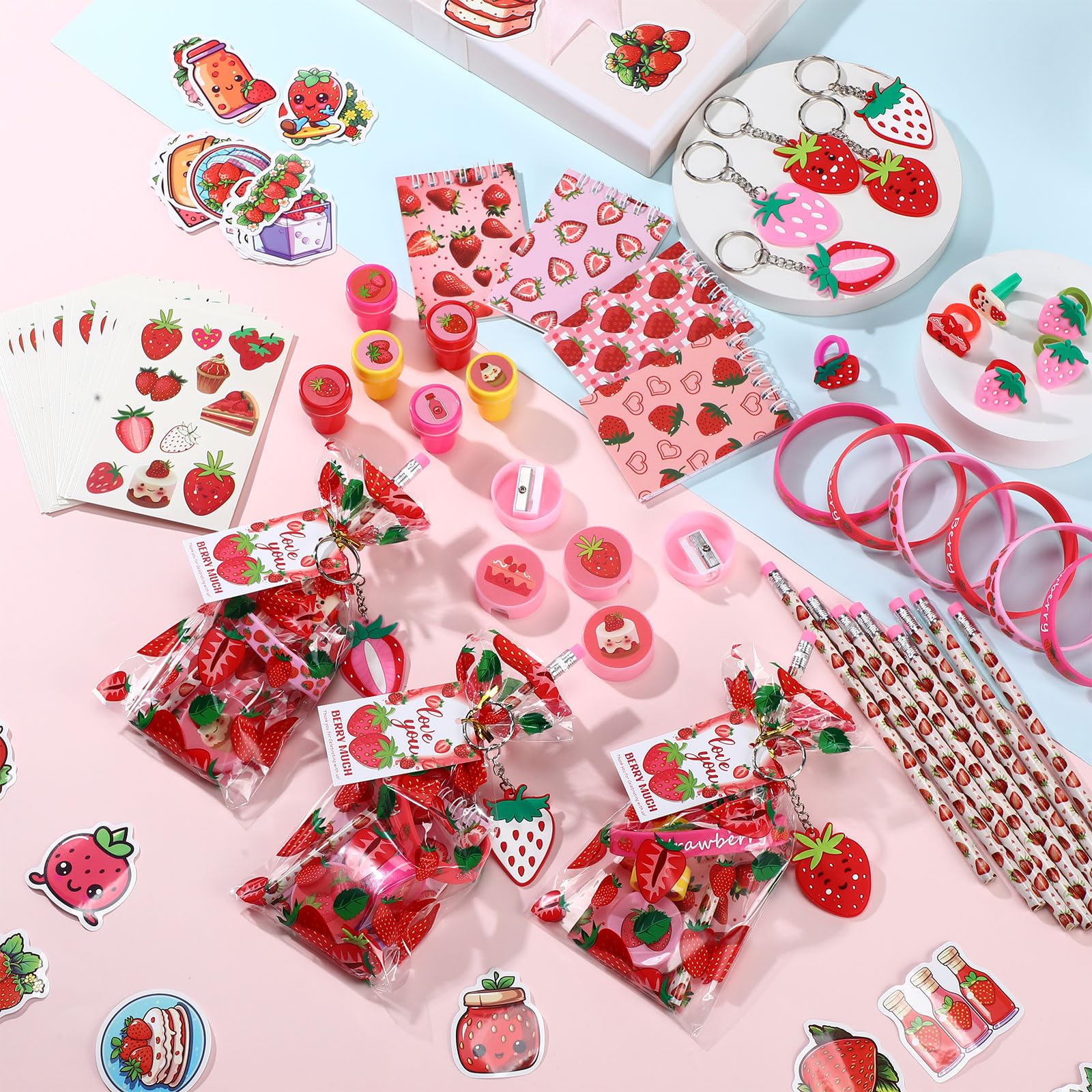 Sayglossy strawberry keychains add portable keepsakes for guests.