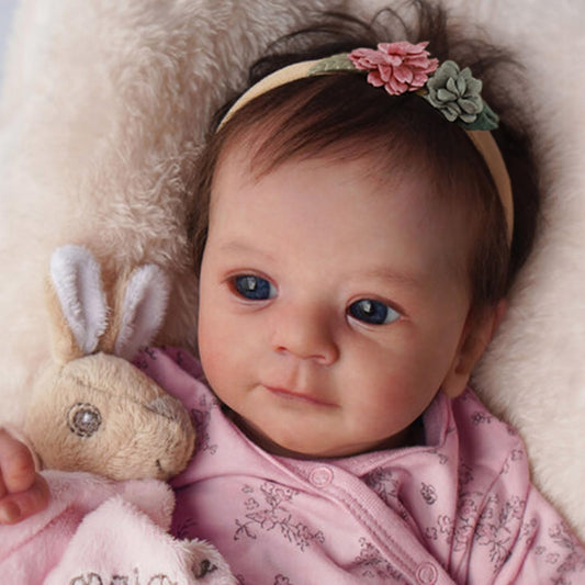 SCOM Felicia in pink floral onesie, ideal for cuddling and imaginative play.