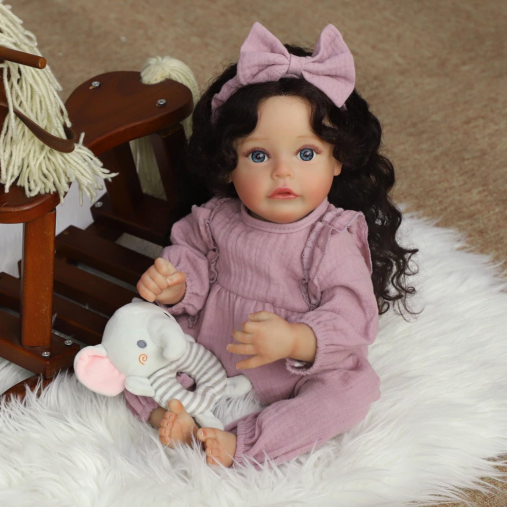 SCOM lifelike reborn doll posed in a nursery setup for storytelling play.