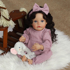 SCOM lifelike reborn doll posed in a nursery setup for storytelling play.