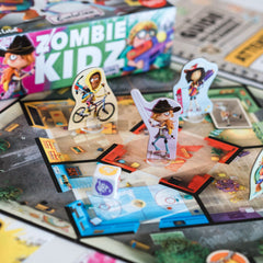 A group sits at a table enjoying cooperative play with Scorpion Masqué Zombie Kidz Evolution.