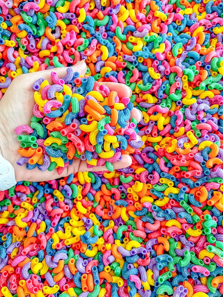 Sensory-N-Stuff colored pasta supports fine motor play in themed activities.