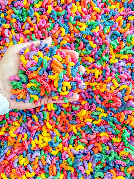 Sensory-N-Stuff colored pasta supports fine motor play in themed activities.