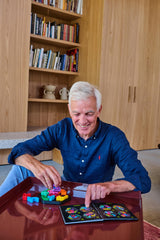 SmartGames IQ Deluxe puzzle close-up – tactile pieces and hexagon layout.