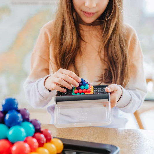 SmartGames IQ Puzzler Pro board with transparent lid ready for quick challenges.