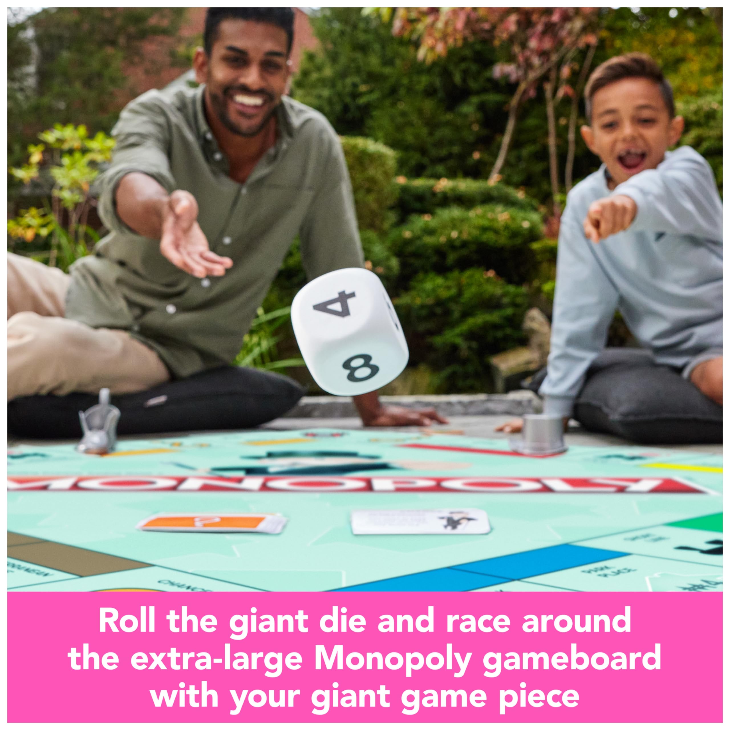 Spin Master Games Monopoly Giant Edition property cards and money meters track wealth.