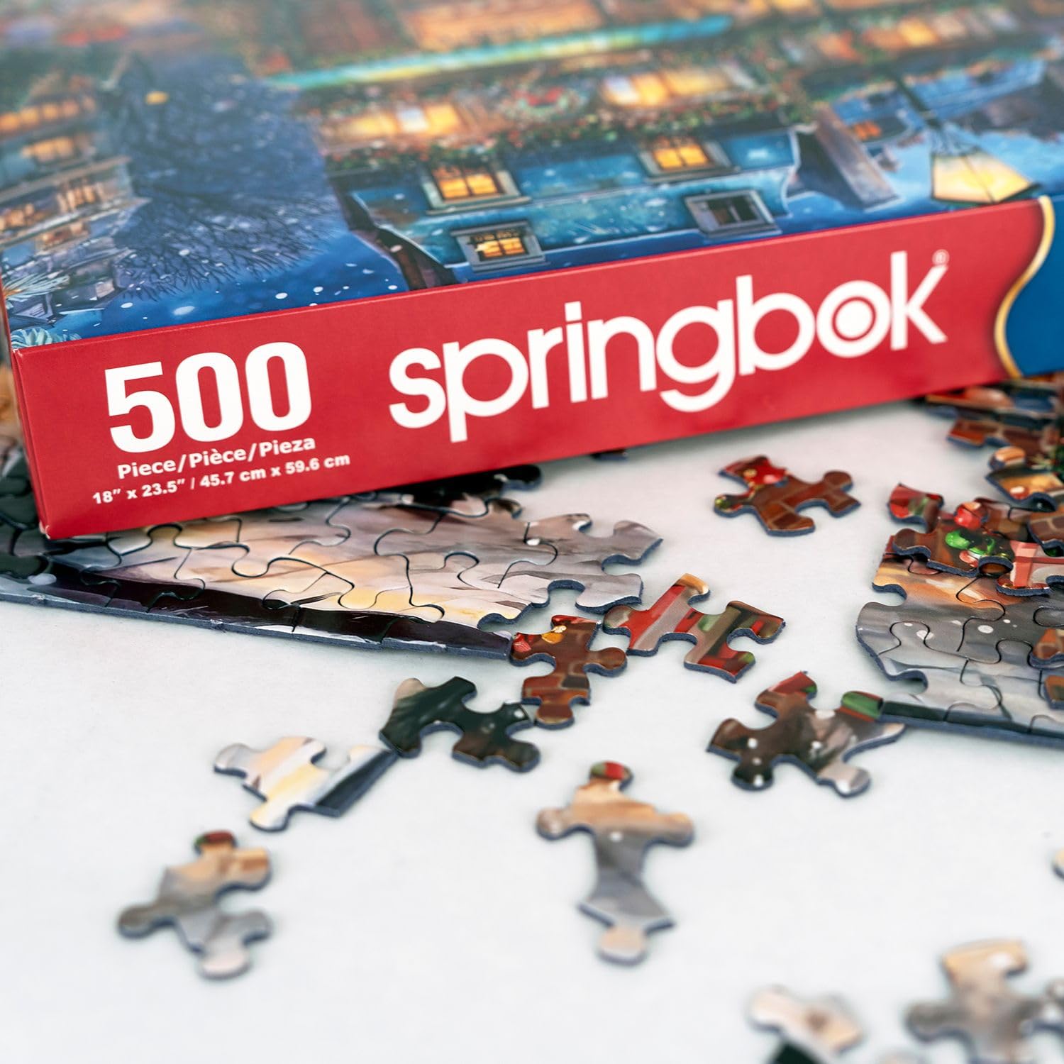 Springbok Winter Wonderland Cafe puzzle captures a warm sidewalk-dining moment with hot drinks.