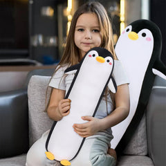 Sprinqdawin penguin pillow on sofa in a living room.
