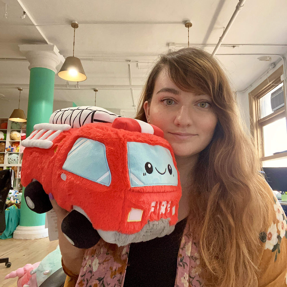 Squishable GO! Fire Truck 12in cozy desk reading nook setup, showcasing ultra-soft texture