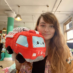 Squishable GO! Fire Truck 12in cozy desk reading nook setup, showcasing ultra-soft texture