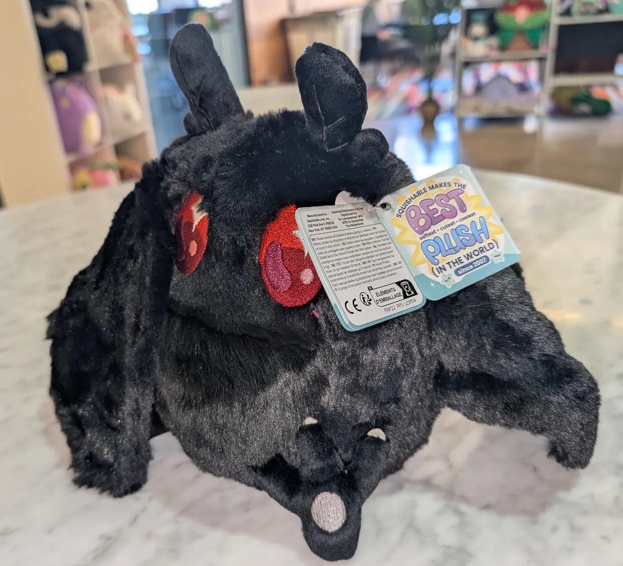 Close-up fur texture of Squishable Mini Baby Mothman, plush and cozy