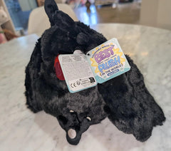 Squishable Mini Baby Mothman on a desk, a sensory-friendly companion