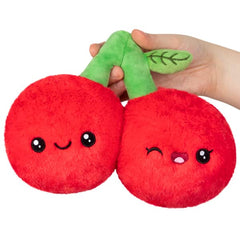 Squishable Snugglemi Snacker Cherries on a cozy desk setup for decor