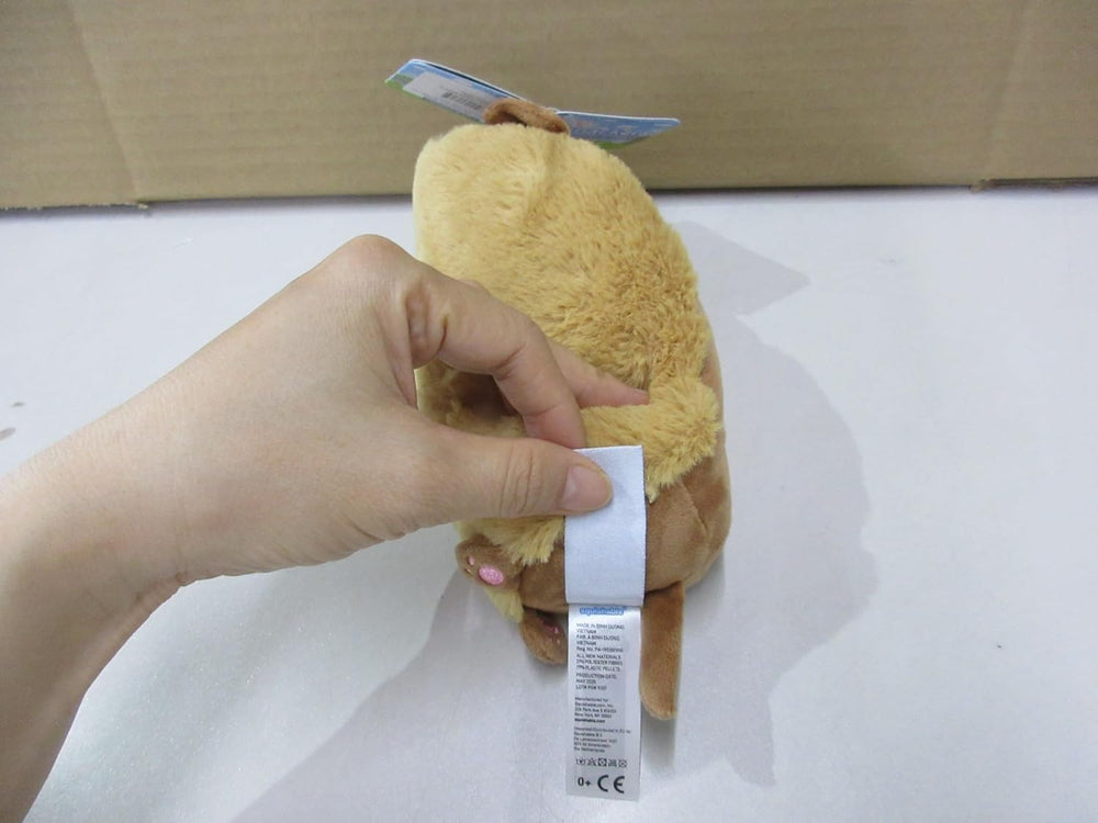 Squishable Snugglemi Snackers Dachshund Hot Dog near bed, perfect gift for cozy moments.